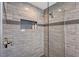 Modern shower with gray tile and glass enclosure at 128 Sinclair Se St, Port Charlotte, FL 33952