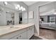 Bathroom with a single sink vanity, mirror, and view to the bedroom at 144 Wild Palm Dr, Bradenton, FL 34210
