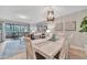 White dining set in a well lit dining area with hardwood floors at 144 Wild Palm Dr, Bradenton, FL 34210