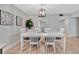 Elegant dining room with white table and chairs, hardwood floors at 144 Wild Palm Dr, Bradenton, FL 34210