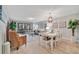 Bright dining room with white table and chairs, and hardwood floors at 144 Wild Palm Dr, Bradenton, FL 34210