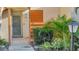 Condo entryway with gray door and surrounding shrubs at 144 Wild Palm Dr, Bradenton, FL 34210