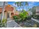 Condo building exterior with walkway and tropical landscaping at 144 Wild Palm Dr, Bradenton, FL 34210
