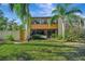 Back exterior view, two-story building with lush landscaping at 144 Wild Palm Dr, Bradenton, FL 34210