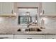 Granite countertops and a pass-through window overlooking living area at 144 Wild Palm Dr, Bradenton, FL 34210