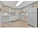 Updated kitchen with white cabinets, granite counters, and tile floors at 144 Wild Palm Dr, Bradenton, FL 34210
