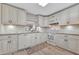 Updated kitchen with white cabinets, granite counters, and tile floors at 144 Wild Palm Dr, Bradenton, FL 34210