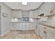 Updated kitchen with white cabinets, granite counters, and tile floors at 144 Wild Palm Dr, Bradenton, FL 34210