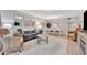 Open living space with gray sofa and wicker armchairs at 144 Wild Palm Dr, Bradenton, FL 34210