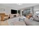 Living area with gray sofa and wicker chairs, hardwood floors at 144 Wild Palm Dr, Bradenton, FL 34210