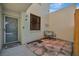 Private patio with wrought iron bench and tile flooring at 144 Wild Palm Dr, Bradenton, FL 34210