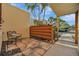 Small patio area with bench and wood privacy wall at 144 Wild Palm Dr, Bradenton, FL 34210