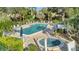 Relaxing community pool and hot tub with ample lounge chairs at 144 Wild Palm Dr, Bradenton, FL 34210