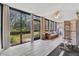 Sunroom with large windows, wicker furniture, and rowing machine at 144 Wild Palm Dr, Bradenton, FL 34210