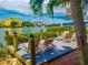 Relaxing patio furniture on a waterfront dock at 1552 Stickney Point Rd # 403, Sarasota, FL 34231
