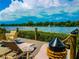 Waterfront dock with lounge chairs and small table at 1552 Stickney Point Rd # 403, Sarasota, FL 34231