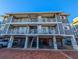 Three-story building with gray siding, balconies, and parking at 1552 Stickney Point Rd # 403, Sarasota, FL 34231