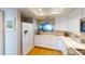 White kitchen with stainless steel appliances and breakfast bar at 1552 Stickney Point Rd # 403, Sarasota, FL 34231
