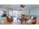 Living room with hardwood floors, sectional sofa and balcony access at 1552 Stickney Point Rd # 403, Sarasota, FL 34231
