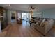 Living room with hardwood floors, sectional sofa, and access to balcony at 1552 Stickney Point Rd # 403, Sarasota, FL 34231