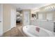 Main bathroom features double sinks, a large soaking tub, and a separate shower at 1577 Taggard Rd, North Port, FL 34288