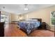 Large bedroom with wood floors, king bed, and access to a back patio at 1577 Taggard Rd, North Port, FL 34288
