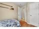 Small bedroom with twin bed, wood floors, and access to a hallway bathroom at 1577 Taggard Rd, North Port, FL 34288