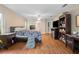 Main bedroom with wood floors, king bed, and en-suite bathroom access at 1577 Taggard Rd, North Port, FL 34288