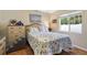 Guest bedroom with floral bedding and large window at 1577 Taggard Rd, North Port, FL 34288