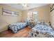 Guest bedroom with two twin beds, wood floors, and coastal decor at 1577 Taggard Rd, North Port, FL 34288