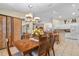 Dining room with wood table and chairs, kitchen view at 1577 Taggard Rd, North Port, FL 34288
