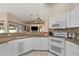 Spacious kitchen with white cabinets, granite countertops, and stainless steel appliances at 1577 Taggard Rd, North Port, FL 34288