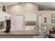 Kitchen features granite countertops, white cabinets and breakfast bar with seating at 1577 Taggard Rd, North Port, FL 34288