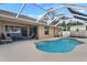 Backyard pool with screened enclosure and patio at 1577 Taggard Rd, North Port, FL 34288