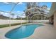 Inviting kidney-shaped pool with screened enclosure at 1577 Taggard Rd, North Port, FL 34288