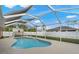 Inviting kidney-shaped pool with screened enclosure at 1577 Taggard Rd, North Port, FL 34288
