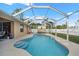Freeform swimming pool with screened enclosure and backyard access at 1577 Taggard Rd, North Port, FL 34288