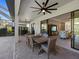 Outdoor patio with dining area, adjacent to the living room and pool at 16203 Tradewind Ter, Lakewood Ranch, FL 34211