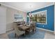 Elegant dining room with a table for six and blue accent wall at 16203 Tradewind Ter, Lakewood Ranch, FL 34211