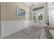 Bright and airy entryway with elegant chandelier and wood wall at 16203 Tradewind Ter, Lakewood Ranch, FL 34211
