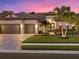Two-car garage, inviting entryway, and manicured lawn at 16203 Tradewind Ter, Lakewood Ranch, FL 34211
