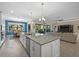 Open kitchen with large island, stainless steel appliances, and views to the living and dining areas at 16203 Tradewind Ter, Lakewood Ranch, FL 34211