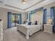 Spacious main bedroom with king-size bed and access to patio at 16203 Tradewind Ter, Lakewood Ranch, FL 34211
