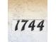 Close-up of house number 1744 on a white stucco wall at 1744 10Th St, Sarasota, FL 34236