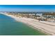 Aerial view of beach with clear water and beachfront homes at 1751 Beach Rd # 404, Englewood, FL 34223