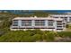 Condo building exterior showcasing waterfront location and balconies at 1751 Beach Rd # 404, Englewood, FL 34223