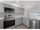Modern kitchen with stainless steel appliances and quartz countertops at 1751 Beach Rd # 404, Englewood, FL 34223