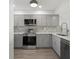 Modern kitchen featuring gray cabinets and stainless steel appliances at 1751 Beach Rd # 404, Englewood, FL 34223