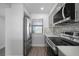 Modern kitchen with stainless steel appliances and gray cabinets at 1751 Beach Rd # 404, Englewood, FL 34223