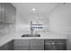 Kitchen sink with view into living room and waterfront at 1751 Beach Rd # 404, Englewood, FL 34223